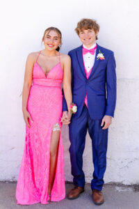 high school boy and girl wearing their prom dresses and suit