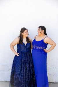 twin high school seniors wearing their blue prom dresses