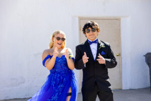 high school boy and girl wearing their prom attire with sunglasses on