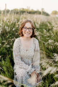 nebraska senior photography in st paul with a senior in some tall grass 