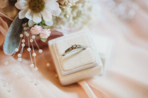 bridal ring in a ring box with flowers near