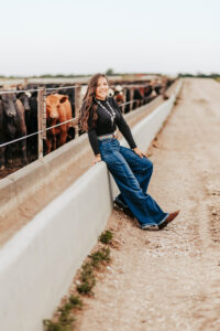 high school senior posing at their family farm for pictures