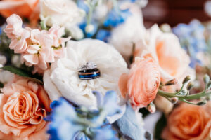 Bridge and groom rings placed on their wedding floral bouquet