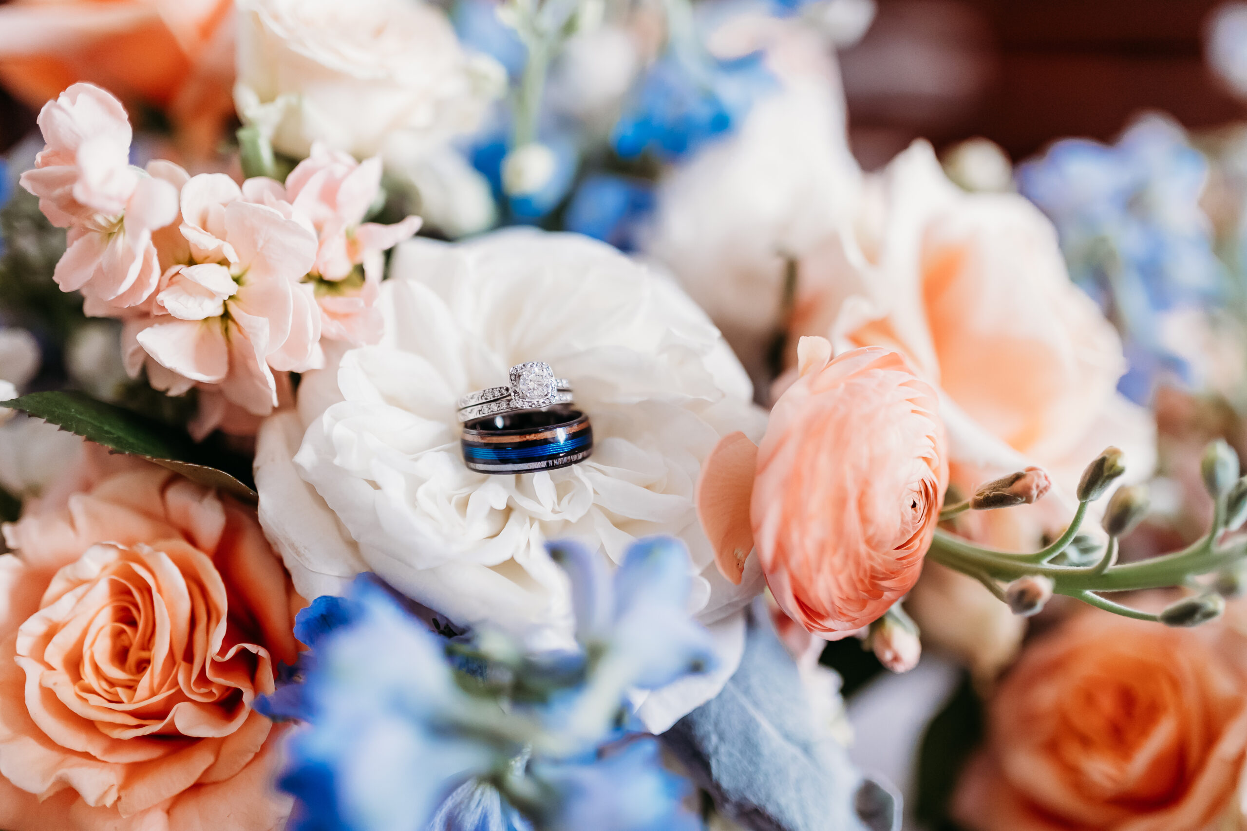 Bridge and groom rings placed on their wedding floral bouquet